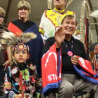 Native youth and community members in regalia at cultural celebration