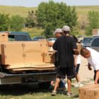 Group unloading boxes from pickup truck in Pine Ridge Indian Reservation