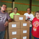 Volunteers with dry food boxes at community distribution site