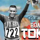 Olympic runner Billy Mills in USA jersey with arms raised
