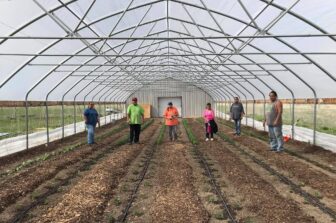 Medicine Root Garden partipants in hoophouse