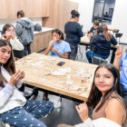 Children and adults are sewing at the Pine Ridge native american community center