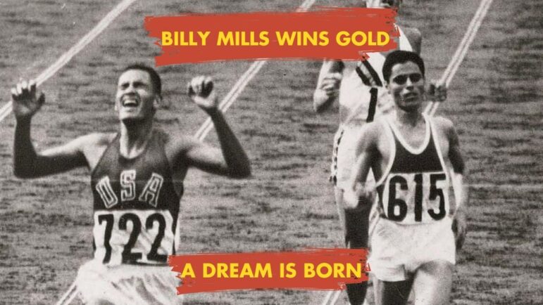 Billy Mills (USA 722) crosses the finish line with arms raised, winning the 10,000m gold medal at the 1964 Tokyo Olympics.