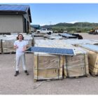 Dreamstarter recipient standing next to solar panels, working on a sustainable energy project to benefit Native communities.