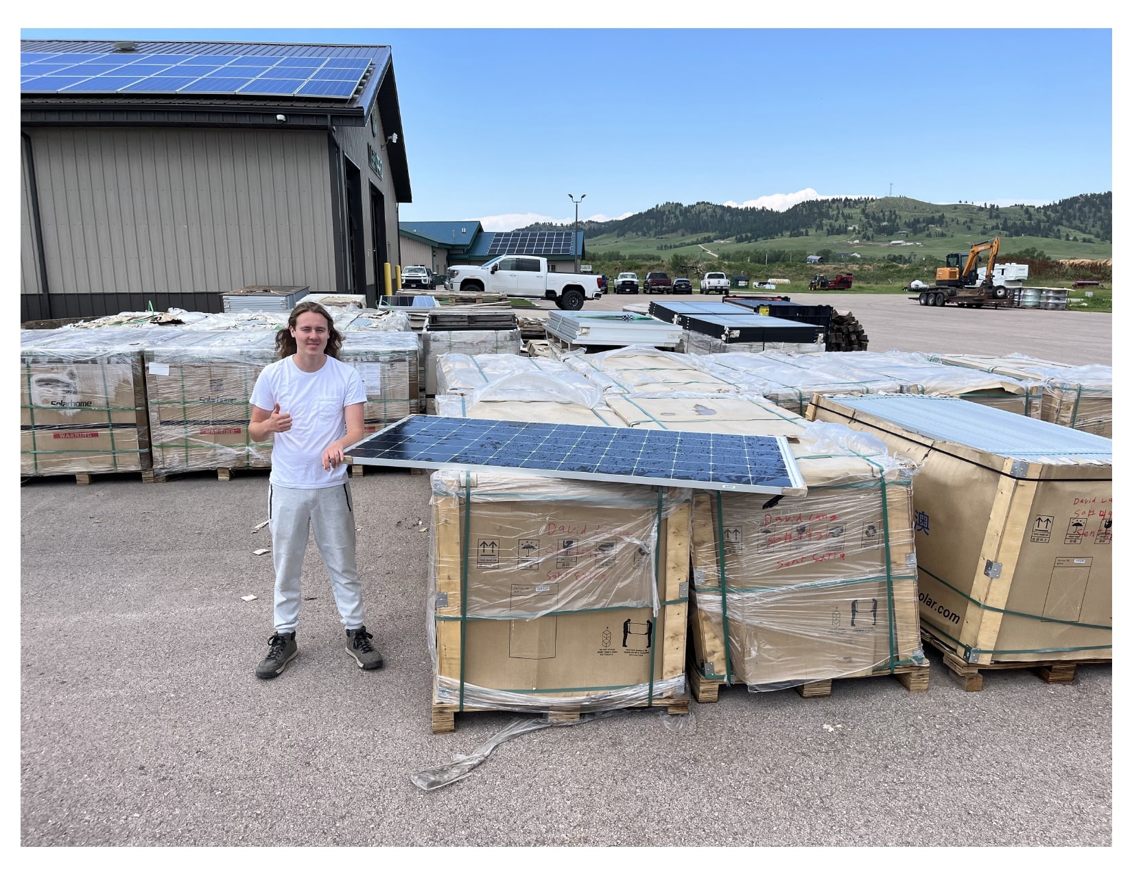 Dreamstarter recipient standing next to solar panels, working on a sustainable energy project to benefit Native communities.