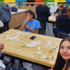 Lakota youth creating traditional breastplates during a cultural crafts class at Oyate Ta Kola Ku.