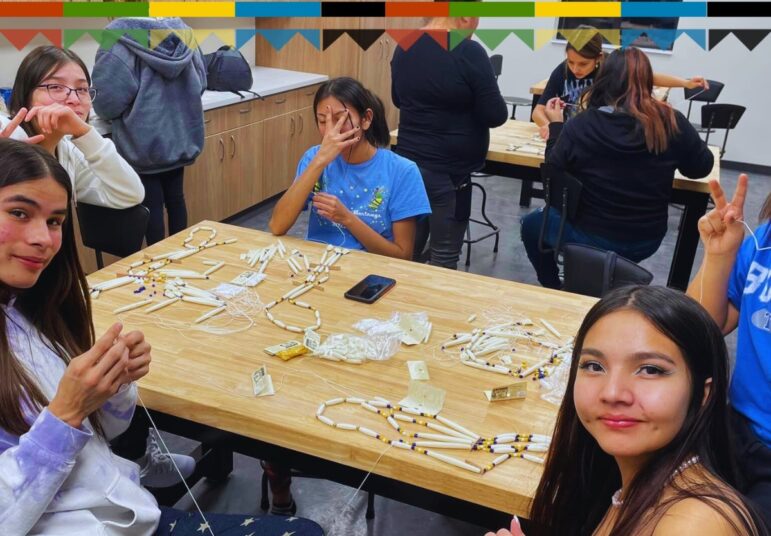 Lakota youth creating traditional breastplates during a cultural crafts class at Oyate Ta Kola Ku.