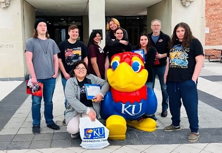 Group of students posing with KU mascot on campus tour