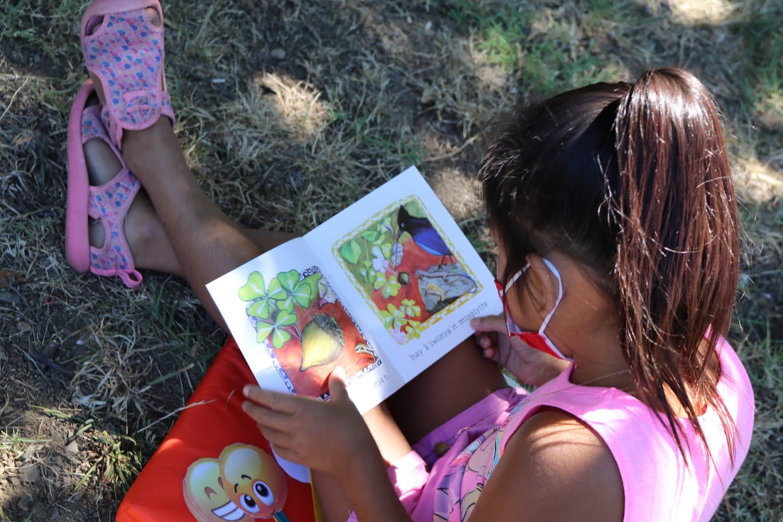 Native girl reading a book