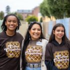 Nizhóní Begay standing with Native students during a college readiness and career exploration program