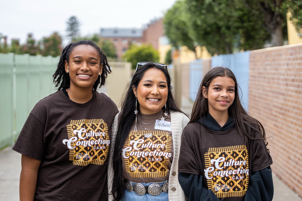 Nizhóní Begay standing with Native students during a college readiness and career exploration program
