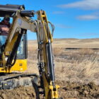 Excavator installing a water line to provide clean water for Native American families on Pine Ridge Reservation