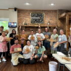 Community members holding handmade rivercane basketry during a workshop led by Aaron Baumgardner of the Catawba Indian Nation