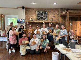 Community members holding handmade rivercane basketry during a workshop led by Aaron Baumgardner of the Catawba Indian Nation