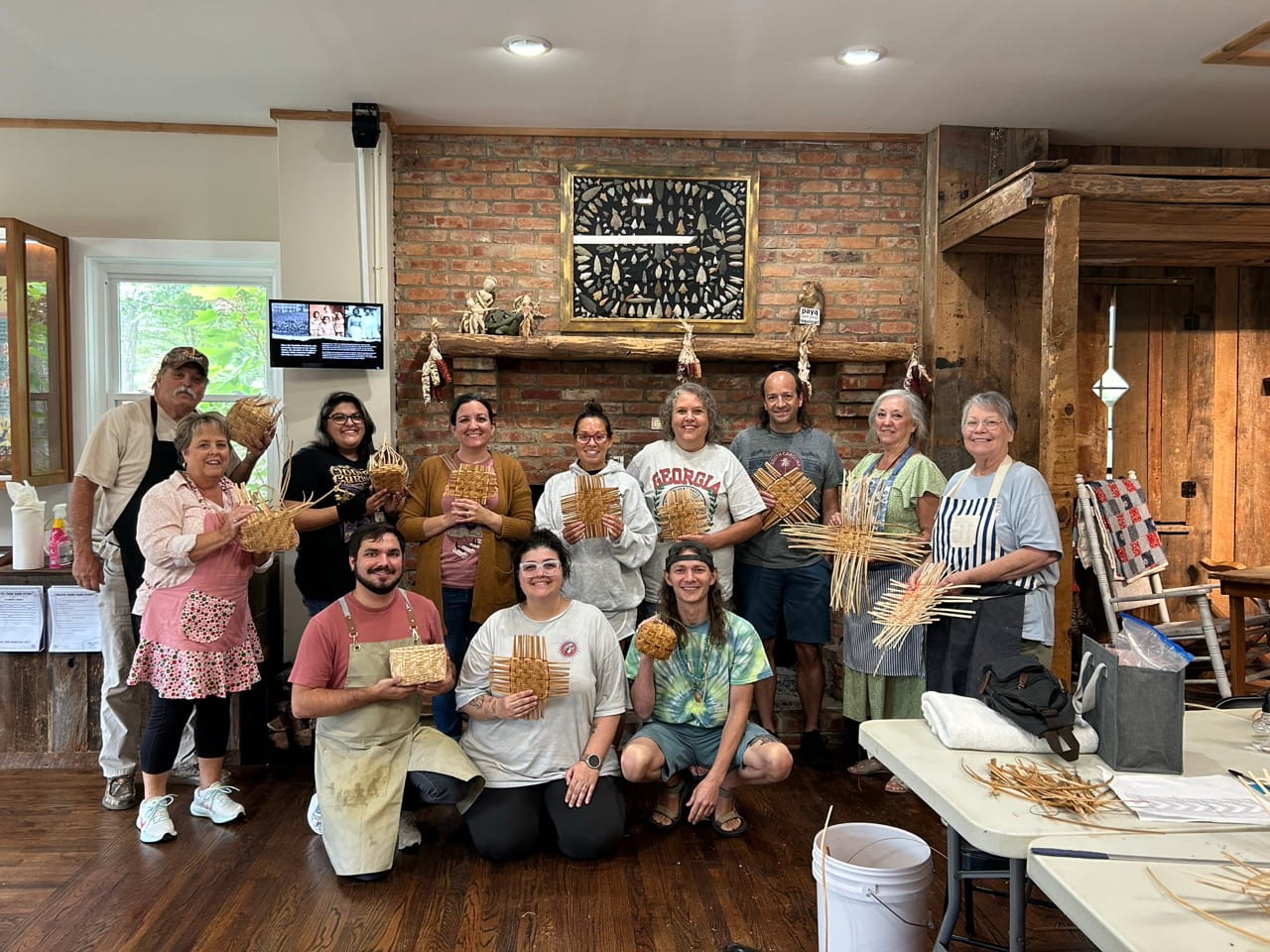 Community members holding handmade rivercane basketry during a workshop led by Aaron Baumgardner of the Catawba Indian Nation