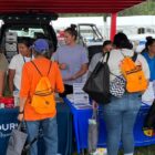Volunteers distribute feminine hygiene kits to Native American families at a community outreach event