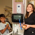 Native dentist teaching young patient proper brushing in dental clinic