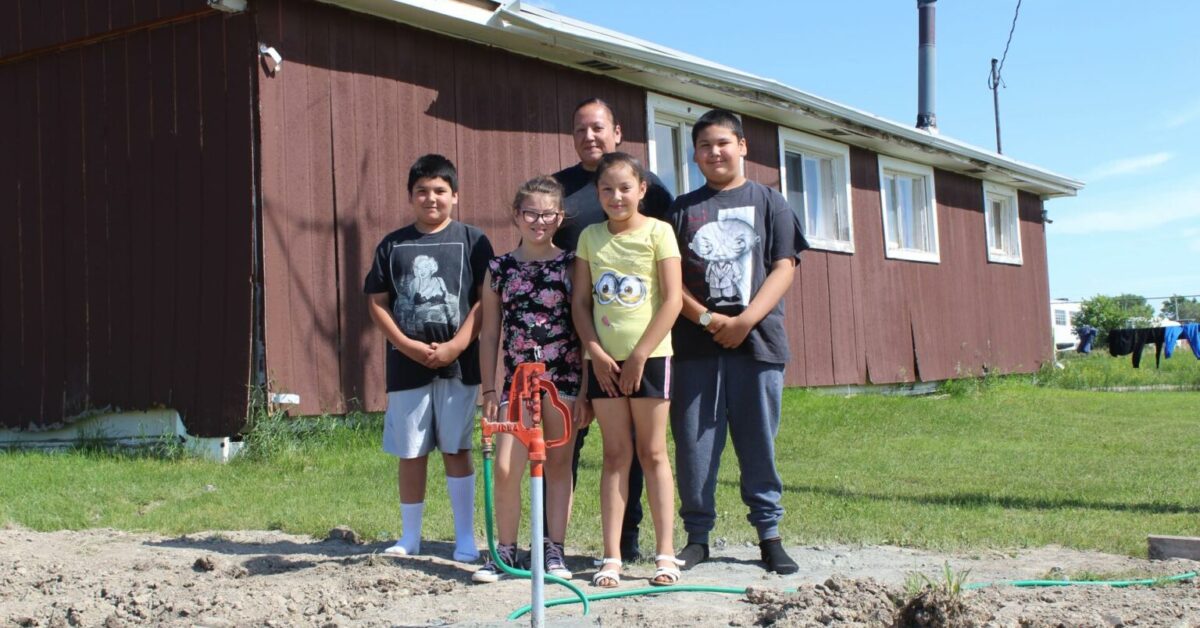 CLEAN WATER Native American family getting access to clan water.