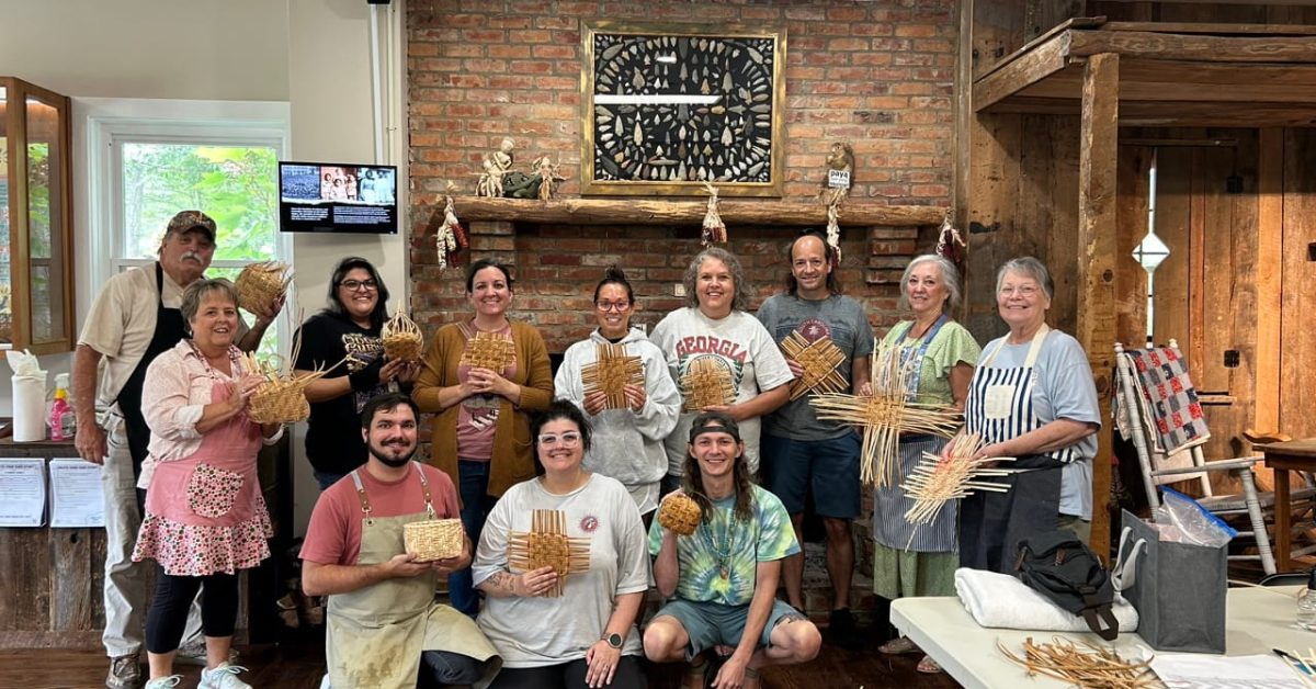 Community members holding handmade rivercane basketry during a workshop led by Aaron Baumgardner of the Catawba Indian Nation