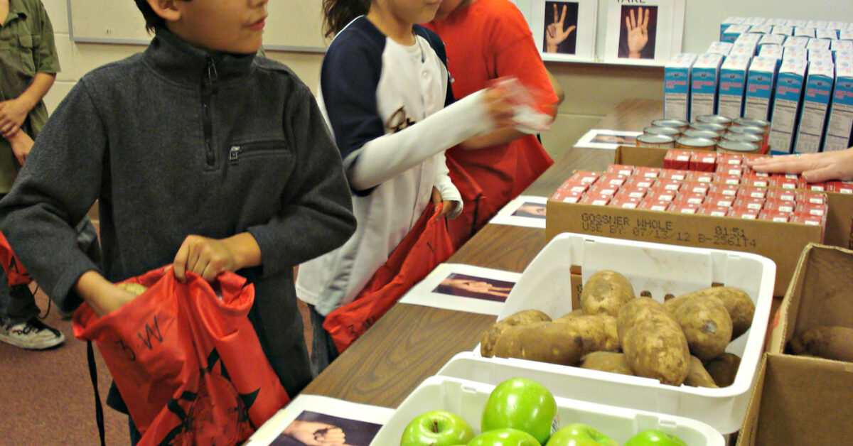 FY12_Menominee_-_children_pack_apples_and_potatoes_-_edited