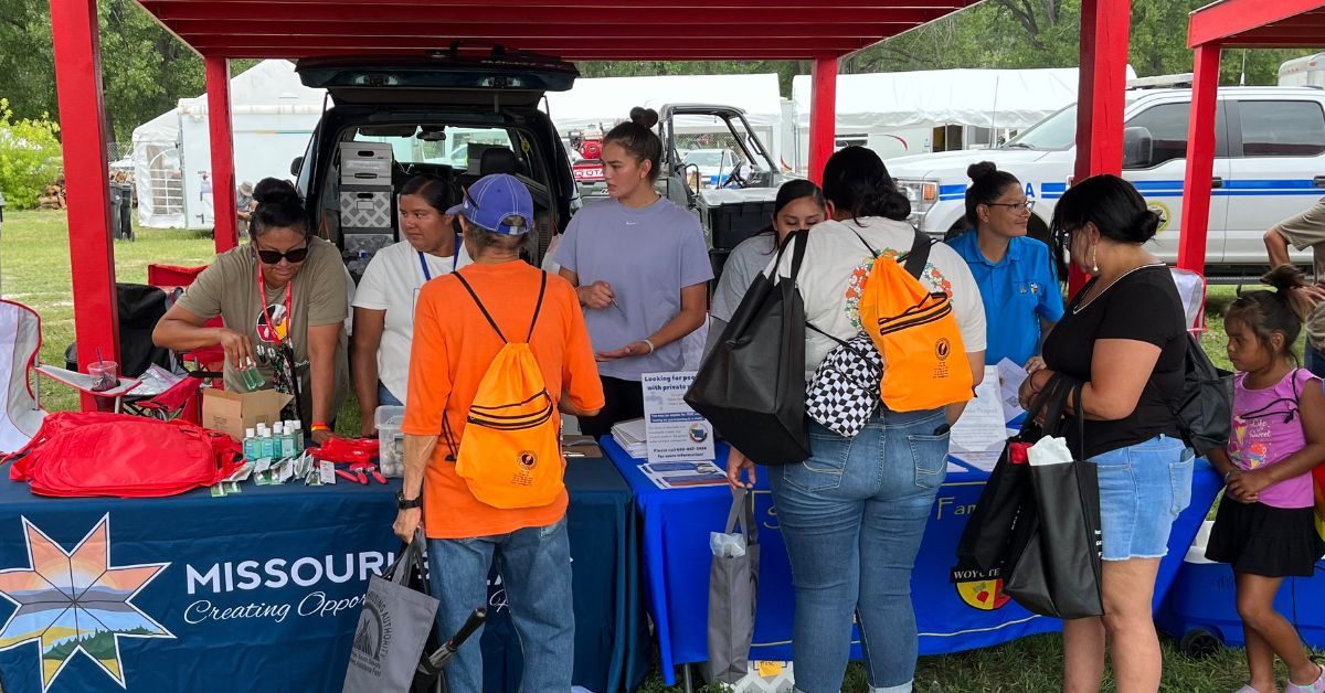 Volunteers distribute feminine hygiene kits to Native American families at a community outreach event