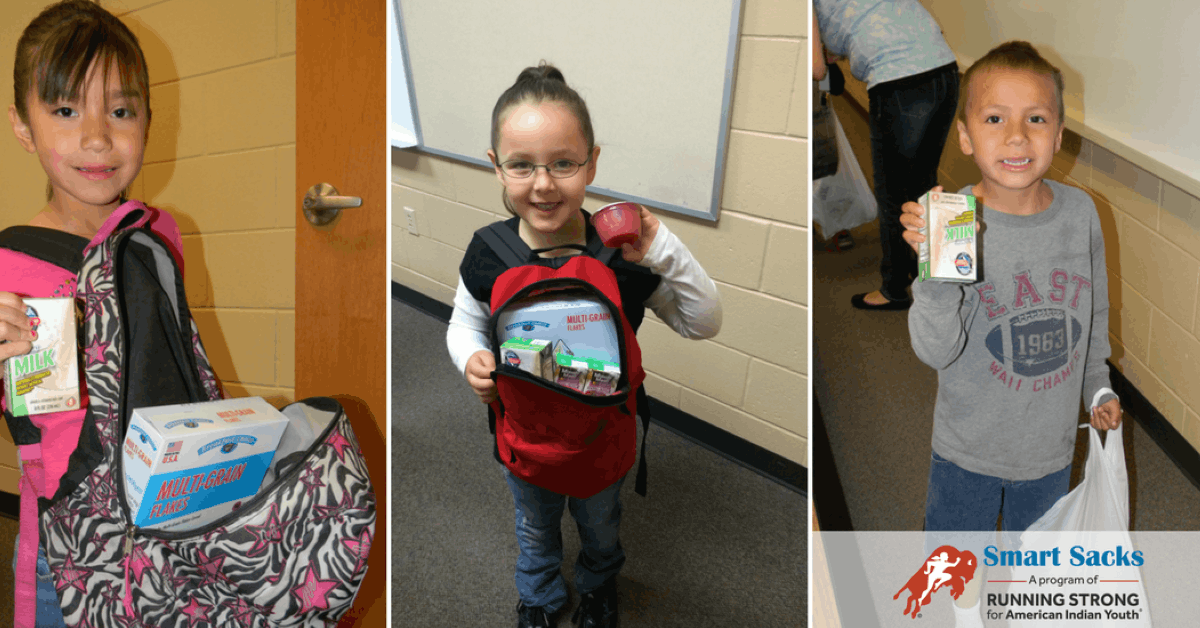 Native American children holding Smart Sacks food items provided to prevent hunger over the weekend
