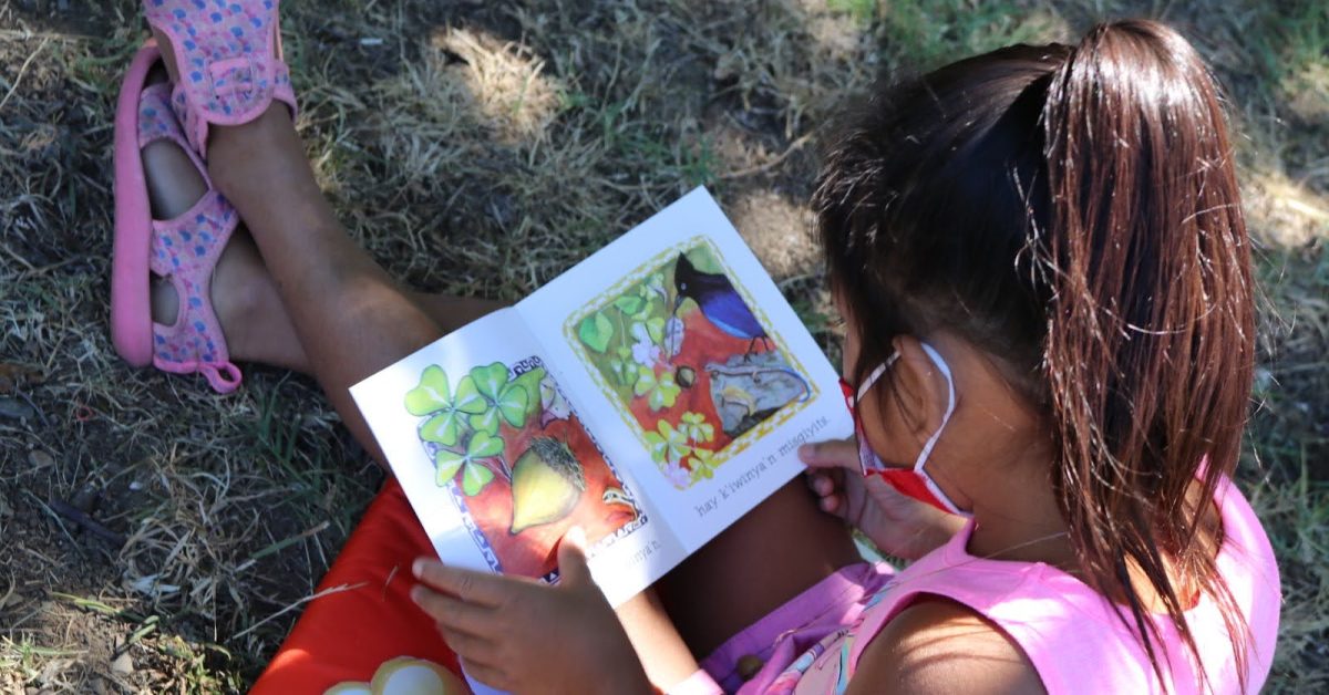 Native girl reading a book