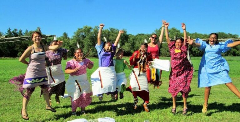 Native American youth jumping and celebrating cultural heritage at a Running Strong youth development event.