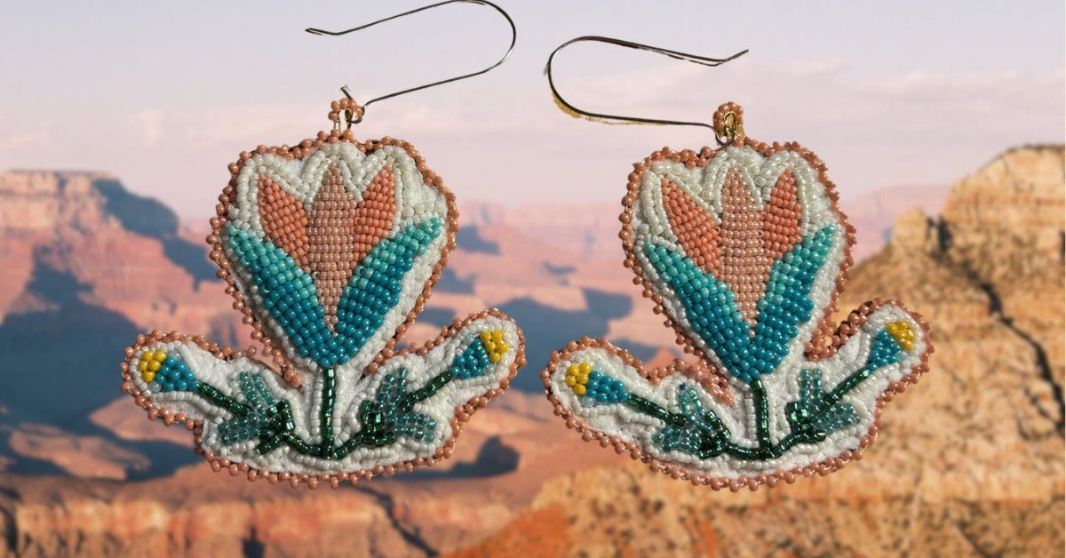 Two floral beaded earrings against a canyon backdrop